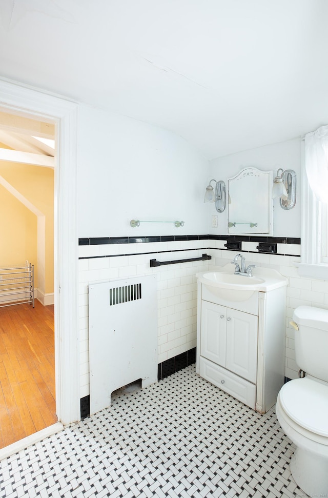 53 Haviland St, Bristol, CT 06010 - bathroom with tile walls, vanity, and a wainscoted wall