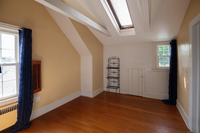 53 Haviland St, Bristol, CT 06010 - additional living space featuring radiator heating unit, vaulted ceiling, wood-type flooring, and a skylight