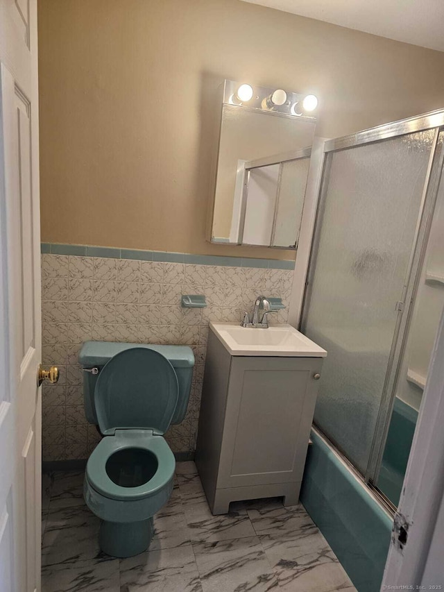 356 Franklin Ave Apt C1, Hartford, CT 06114 - full bath with marble finish floors, vanity, wainscoting, shower / bath combination with glass door, and tile walls
