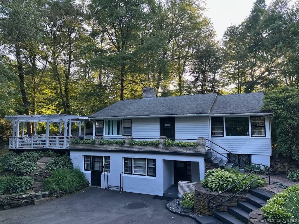 5 Old Orchard Rd, Bloomfield, CT 06002 - view of front of home with stairs, a chimney, and roof with shingles