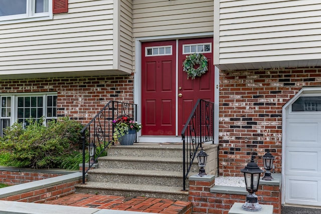 28 Musket Ridge Rd, New Fairfield, CT 06812 - doorway to property featuring brick siding and a garage