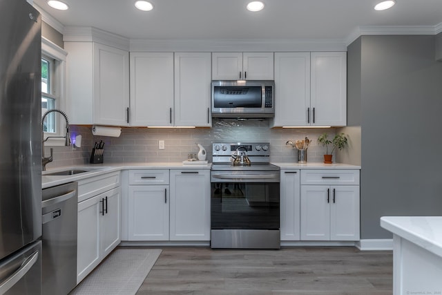 28 Musket Ridge Rd, New Fairfield, CT 06812 - kitchen with appliances with stainless steel finishes, white cabinets, light countertops, crown molding, and recessed lighting