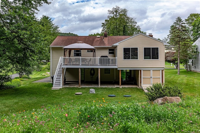 28 Musket Ridge Rd, New Fairfield, CT 06812 - back of property with stairway, a deck, a patio area, a yard, and a chimney