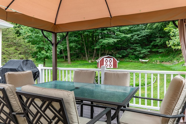 28 Musket Ridge Rd, New Fairfield, CT 06812 - wooden deck featuring outdoor dining area, a shed, and a lawn