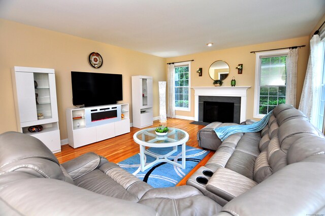 32 Arlington Dr, Avon, CT 06001 - living room featuring light wood-style flooring, a fireplace with flush hearth, and plenty of natural light