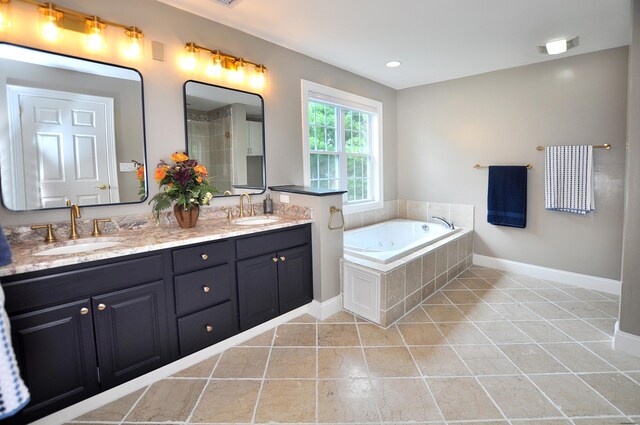 32 Arlington Dr, Avon, CT 06001 - full bath featuring double vanity, a jetted tub, and tile patterned floors