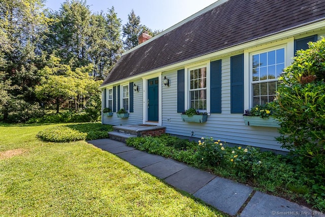 6 Trolley Xing, Old Saybrook, CT 06475 - view of front of house featuring a front yard, a chimney, and roof with shingles