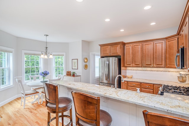 199 Meadow Brook Rd Unit 199, Oxford, CT 06478 - kitchen with stainless steel appliances, light stone countertops, healthy amount of natural light, light wood-style floors, and recessed lighting