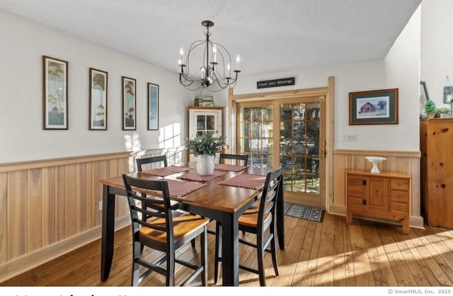 32 Meeks Point Rd, East Hampton, CT 06424 - dining room with a wainscoted wall, a chandelier, wood-type flooring, and wooden walls