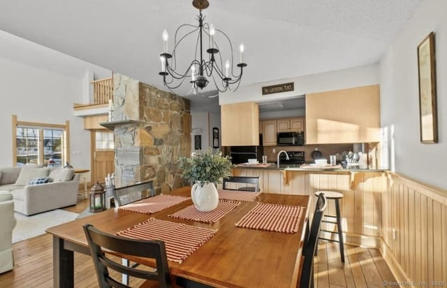 32 Meeks Point Rd, East Hampton, CT 06424 - dining room featuring a chandelier, wood finished floors, and a stone fireplace