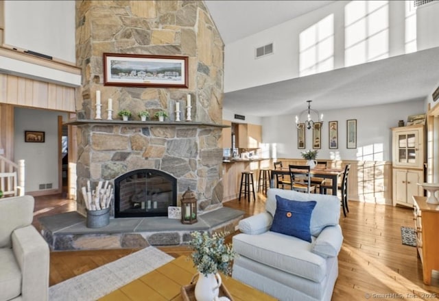 32 Meeks Point Rd, East Hampton, CT 06424 - living area with high vaulted ceiling, wood-type flooring, a fireplace, and a chandelier