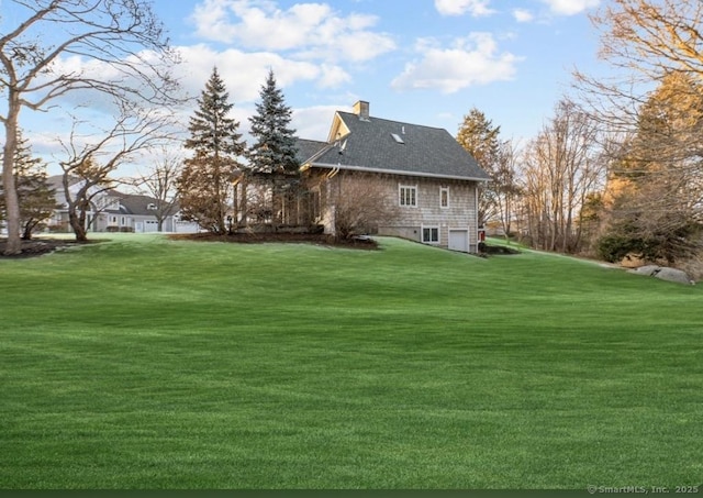 32 Meeks Point Rd, East Hampton, CT 06424 - rear view of house with a garage, a yard, a chimney, and a shingled roof