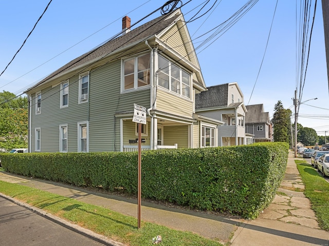 88 Amsterdam Ave, Bridgeport, CT 06606 - view of home's exterior featuring a chimney and a shingled roof