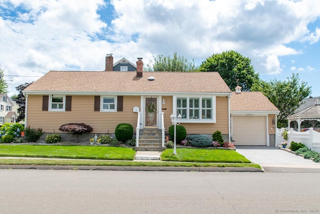 2 Oak Ter, Stratford, CT 06614 - ranch-style house with a chimney, a front lawn, a garage, and driveway