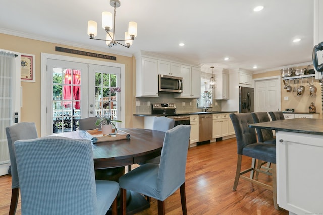 630 Fairview Ave, Bridgeport, CT 06606 - dining area with a chandelier, crown molding, wood finished floors, and recessed lighting