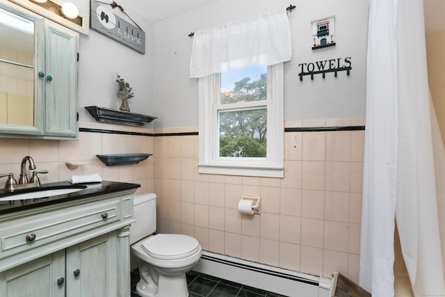 630 Fairview Ave, Bridgeport, CT 06606 - bathroom featuring a baseboard heating unit, tile walls, vanity, tile patterned floors, and wainscoting