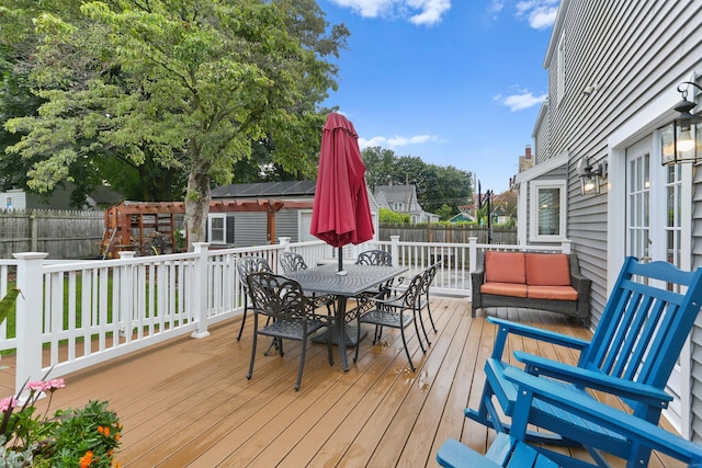 630 Fairview Ave, Bridgeport, CT 06606 - wooden deck with outdoor dining area and a fenced backyard