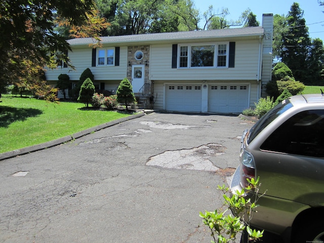 21 Kingswood Rd, Danbury, CT 06811 - raised ranch with a chimney, an attached garage, driveway, and a front lawn