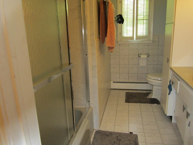 21 Kingswood Rd, Danbury, CT 06811 - full bath featuring baseboard heating, tile patterned floors, vanity, tile walls, and shower / bath combination with glass door