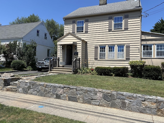 954 Birmingham St, Bridgeport, CT 06606 - view of front of home with a chimney and a front lawn
