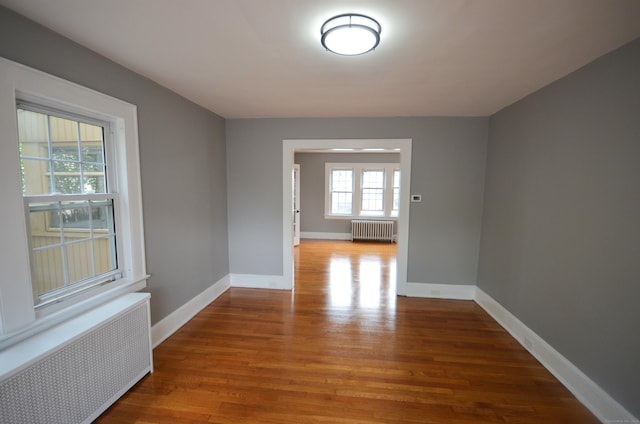 954 Birmingham St, Bridgeport, CT 06606 - empty room featuring radiator and wood finished floors