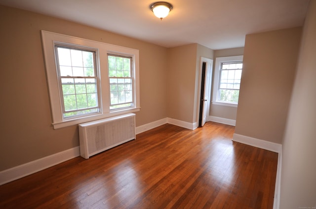 954 Birmingham St, Bridgeport, CT 06606 - empty room featuring radiator heating unit and wood finished floors