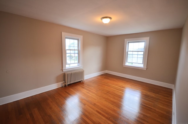 954 Birmingham St, Bridgeport, CT 06606 - unfurnished room featuring radiator, healthy amount of natural light, and wood finished floors