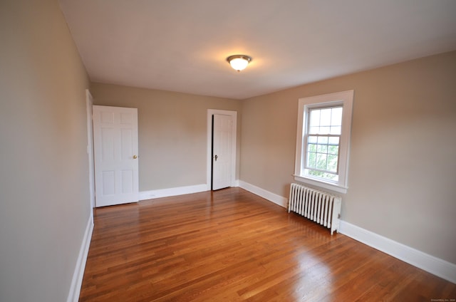 954 Birmingham St, Bridgeport, CT 06606 - unfurnished room with radiator heating unit and wood finished floors