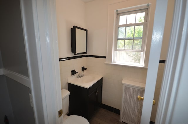 954 Birmingham St, Bridgeport, CT 06606 - half bathroom with tile walls, vanity, and wainscoting