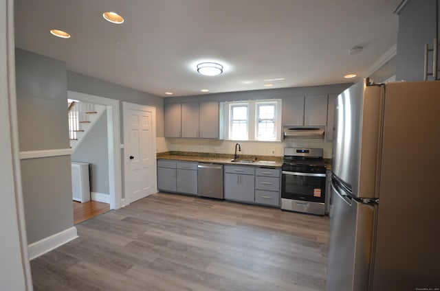 954 Birmingham St, Bridgeport, CT 06606 - kitchen with stainless steel appliances, gray cabinetry, under cabinet range hood, decorative backsplash, and recessed lighting