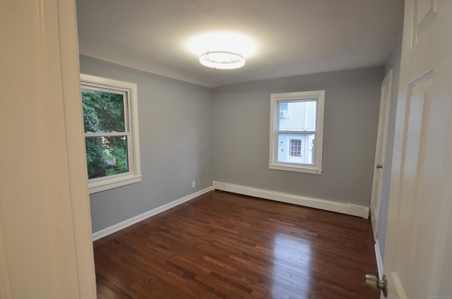 171 Wake St, Bridgeport, CT 06610 - empty room featuring a baseboard heating unit and dark wood-style floors