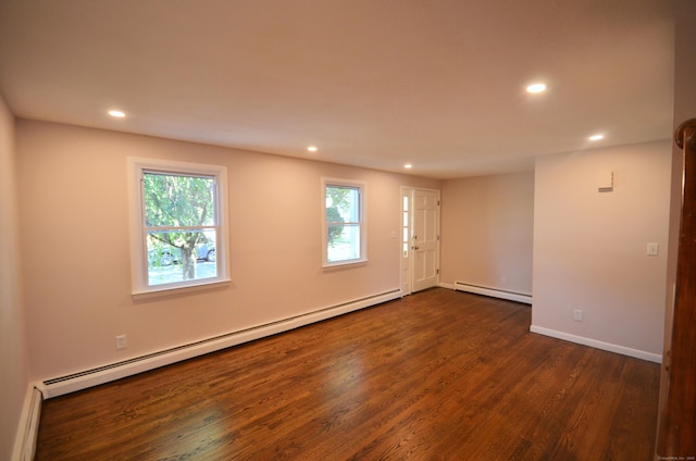 335 Wiklund Ave, Stratford, CT 06614 - empty room with a baseboard heating unit, recessed lighting, healthy amount of natural light, and dark wood-type flooring