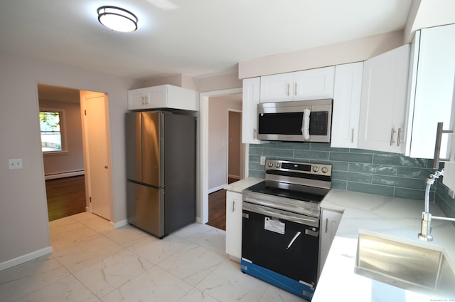 335 Wiklund Ave, Stratford, CT 06614 - kitchen with stainless steel appliances, baseboard heating, white cabinetry, and light stone counters