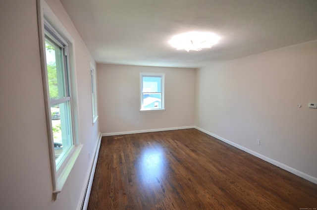 335 Wiklund Ave, Stratford, CT 06614 - spare room with dark wood-style flooring and a baseboard heating unit