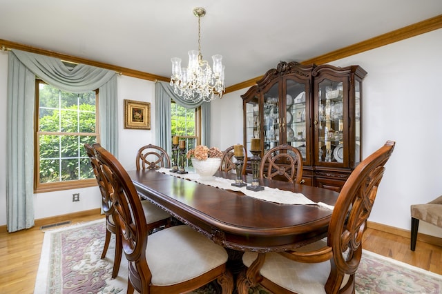 491 Hammertown Rd, Monroe, CT 06468 - dining room with a chandelier, healthy amount of natural light, light wood-type flooring, and crown molding
