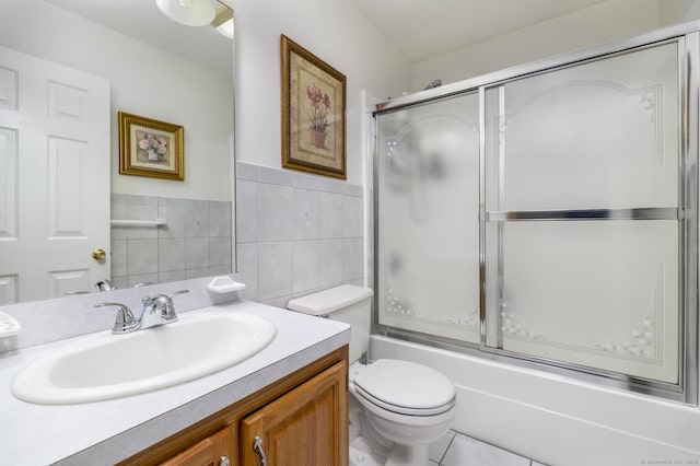 491 Hammertown Rd, Monroe, CT 06468 - bathroom featuring vanity, tile walls, combined bath / shower with glass door, and a wainscoted wall