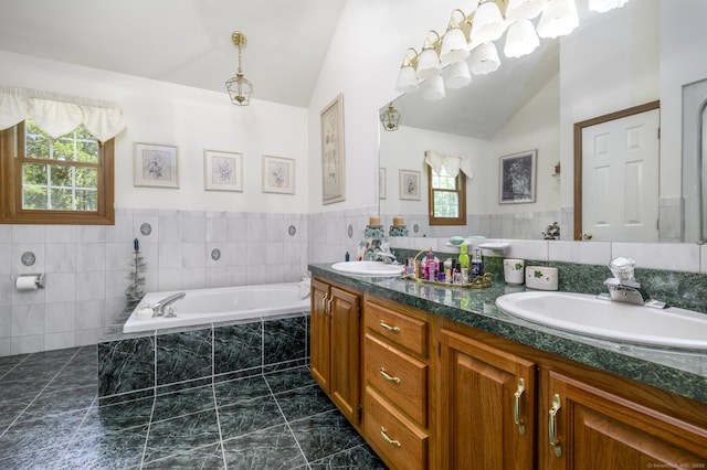 491 Hammertown Rd, Monroe, CT 06468 - bathroom with vaulted ceiling, double vanity, a bath, marble finish flooring, and tile walls
