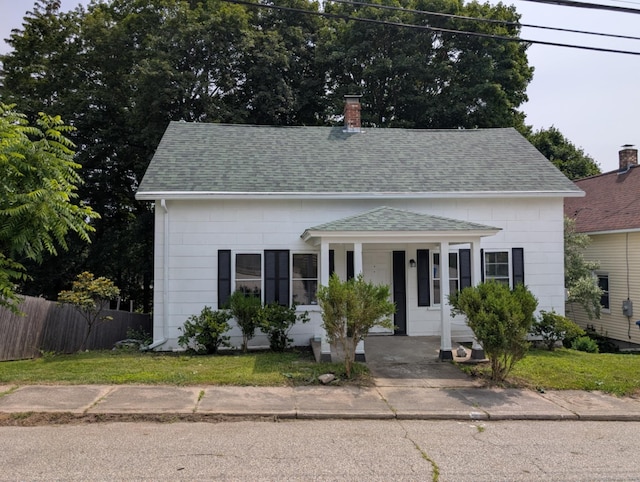 18 Highland St, Plainfield, CT 06354 - view of front of house featuring a shingled roof, covered porch, and a chimney