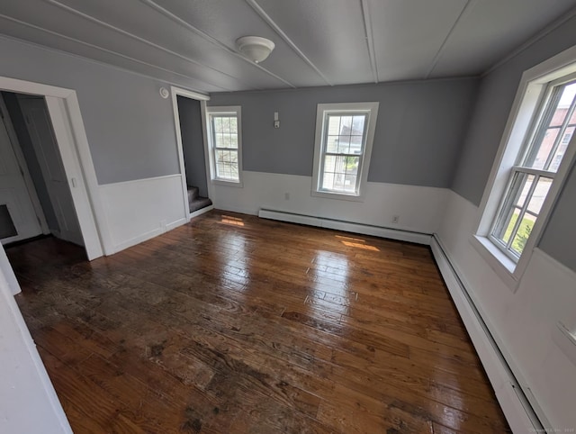 18 Highland St, Plainfield, CT 06354 - empty room with baseboard heating, wood-type flooring, plenty of natural light, and stairs