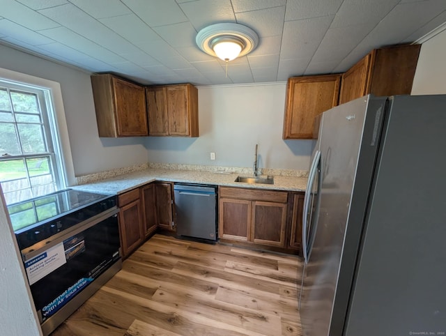 18 Highland St, Plainfield, CT 06354 - kitchen featuring stainless steel appliances, light wood finished floors, brown cabinets, and light stone counters