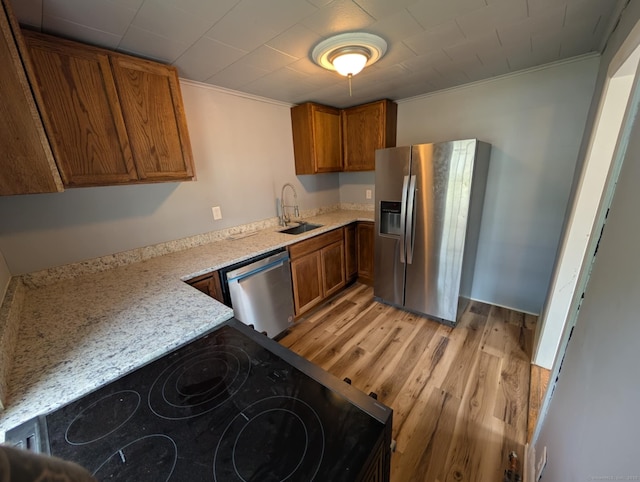 18 Highland St, Plainfield, CT 06354 - kitchen with stainless steel appliances, brown cabinets, light wood-type flooring, and crown molding