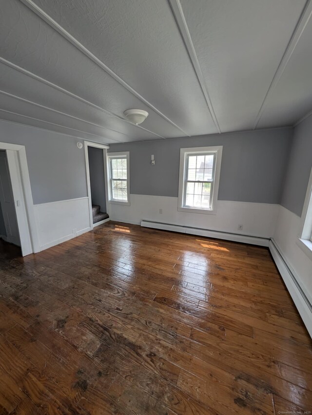 18 Highland St, Plainfield, CT 06354 - empty room featuring hardwood / wood-style floors, stairs, and baseboard heating