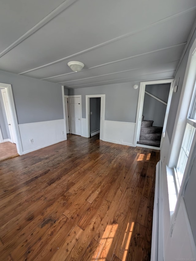 18 Highland St, Plainfield, CT 06354 - spare room with stairs, dark wood finished floors, and wainscoting