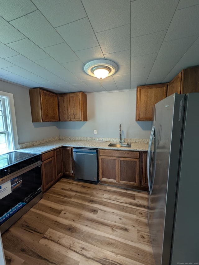 18 Highland St, Plainfield, CT 06354 - kitchen with stainless steel appliances, light wood-style floors, and brown cabinets