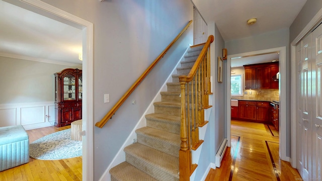 803 Grassy Hill Rd, Orange, CT 06477 - staircase with wood finished floors, wainscoting, and ornamental molding
