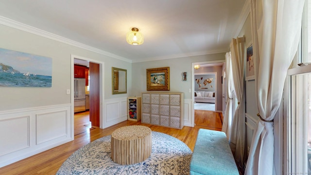 803 Grassy Hill Rd, Orange, CT 06477 - living area with ornamental molding, light wood-style floors, and a wainscoted wall