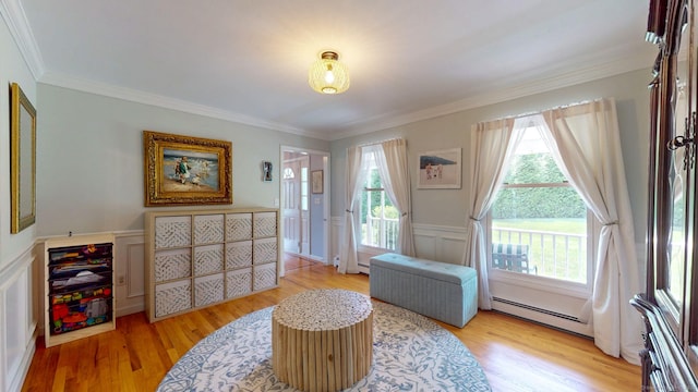 803 Grassy Hill Rd, Orange, CT 06477 - sitting room featuring a baseboard radiator, a decorative wall, light wood-style flooring, crown molding, and wainscoting