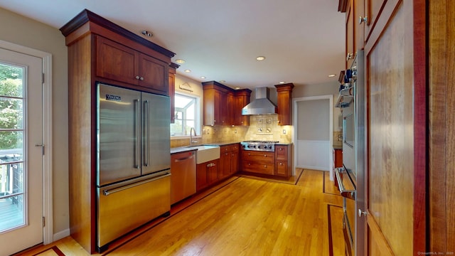 803 Grassy Hill Rd, Orange, CT 06477 - kitchen featuring stainless steel appliances, wall chimney range hood, plenty of natural light, light wood-type flooring, and recessed lighting
