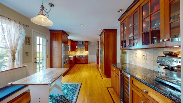 803 Grassy Hill Rd, Orange, CT 06477 - kitchen featuring wall chimney range hood, appliances with stainless steel finishes, wine cooler, decorative backsplash, and light wood-type flooring