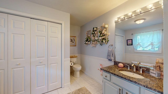 803 Grassy Hill Rd, Orange, CT 06477 - bathroom featuring a closet, vanity, tile patterned floors, and a wainscoted wall